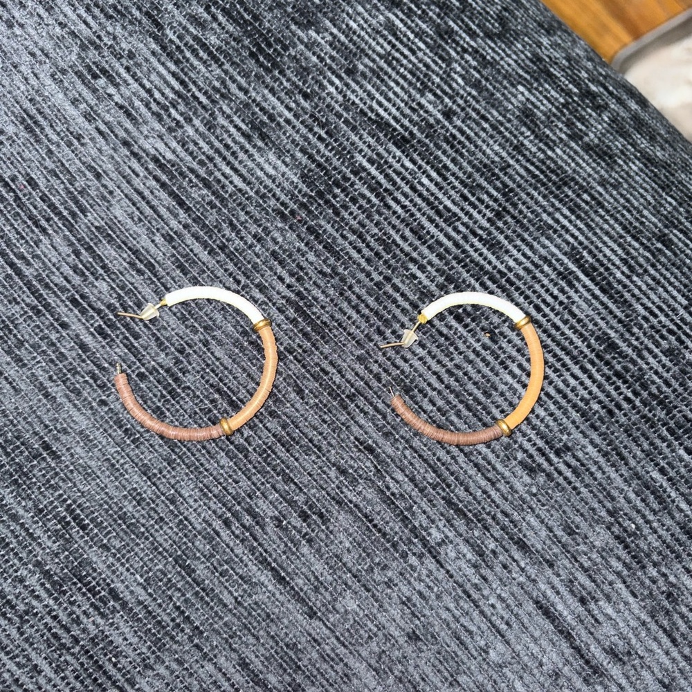 open hoop earrings featuring a colorful, wrapped thread or bead design.